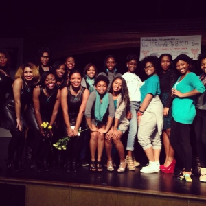 Epsilon Iota Psi sorority pose on a stage