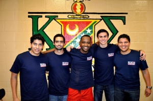 Kappa Sigma fraternity pose in front of a wall painted with their crest.